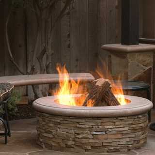 Stacked-stone round fire pit with live flames